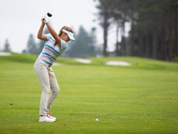Golfer on golf course taking a swing