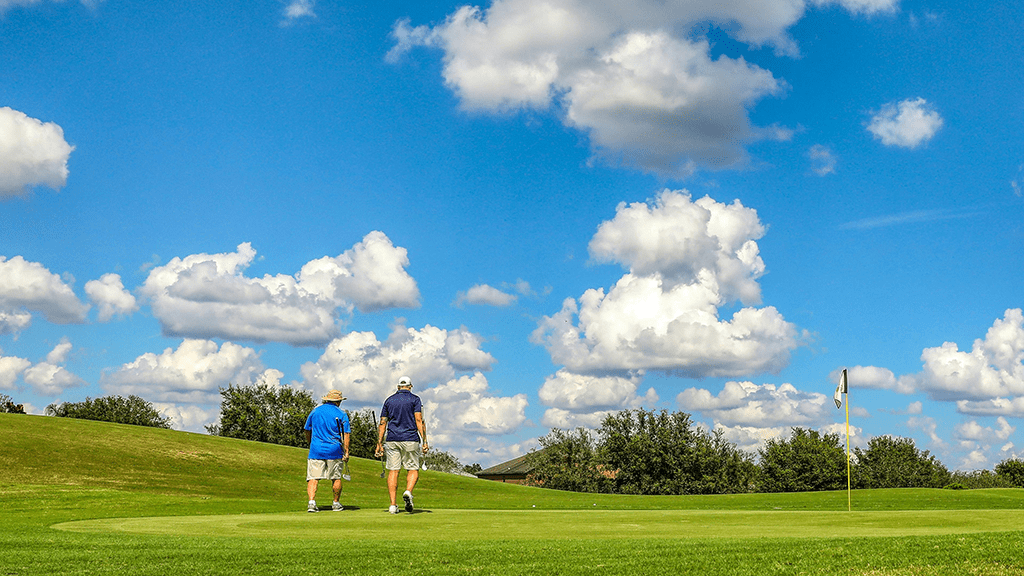 Golfers walking on course