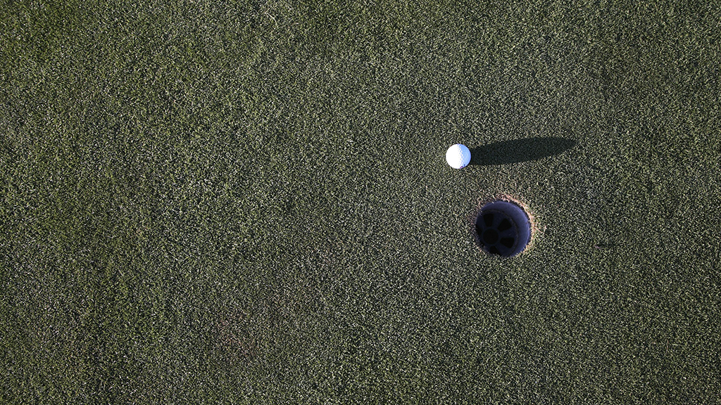 Golf Ball near hole 